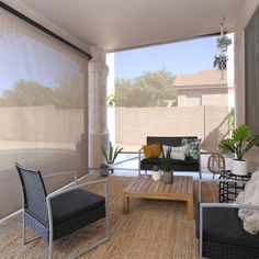 a living room with two chairs and a coffee table on the floor in front of an open patio door