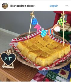 a table topped with lots of food on top of a wooden table covered in flags