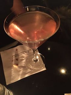 a close up of a wine glass on a table with a napkin in front of it