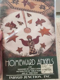 someone is holding up a sewing pattern for a homeward angels ornament