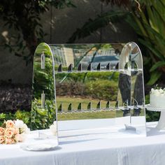 a wedding cake and mirror on a table