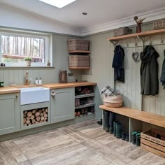 a kitchen filled with lots of counter space and wooden flooring next to a window