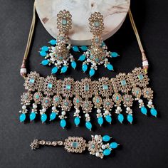 Elevate your bridal look with our exquisite Sea Blue Crystal Indian Choker Necklace set. Adorned with suspended beads, embellished Polki stones, and pearls, this Pakistani Jewelry masterpiece exudes elegance and charm. Perfect for your special day! ❋❋ This set includes - 1 Choker Necklace, 1 Maang Tikka, 1 pair of Earring ❋❋ ❋❋ Shipping Methods ❋❋ Standard Delivery - Take up to 8-14 business days (Worldwide). ❋❋ Please be aware that the colors, shades, and texture shown may exhibit minor variati Festive Multicolor Stone Work Choker, Wedding Multicolor Stone Work Choker, Multicolor Meenakari Choker Necklace, Luxury Meenakari Choker For Festivals, Bollywood Meenakari Choker Jewelry Set, Indian Choker Necklace, Bridal Choker, Choker Necklace Set, Pakistani Jewelry