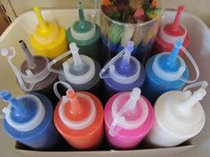 a box filled with lots of different colored baby bottles