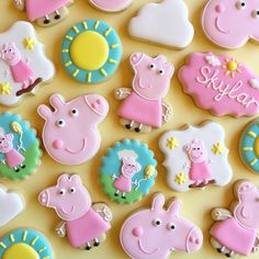 decorated cookies are arranged in the shape of farm animals and pig's on display