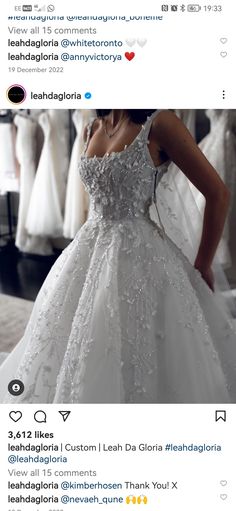 a woman in a wedding dress looking down at her dress on the screen, which is being displayed