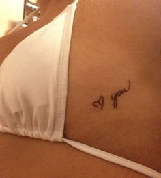 a woman's stomach with the word love written in cursive writing on it