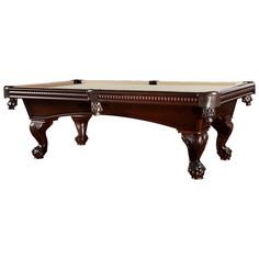 an antique pool table with marble top and carved wood trimmings on the legs