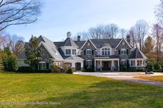 a large house with lots of windows in the front yard