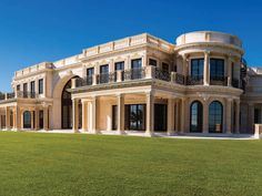 a large house with many windows and balconies on the top floor is shown