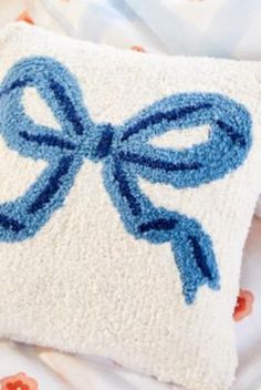 a white pillow with a blue bow on it