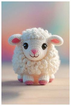 a small white sheep sitting on top of a wooden table next to a pink and blue background