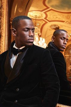 two men in tuxedos standing next to each other