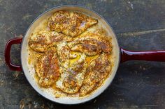 a pan filled with food sitting on top of a wooden table