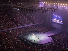 an aerial view of a large crowd at a concert, with the stage lit up