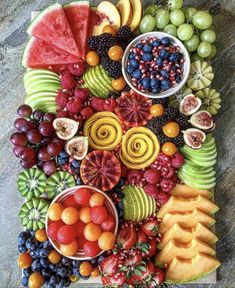 a variety of fruits are arranged on a cutting board