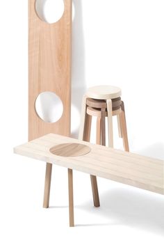 two stools and a table made out of wood