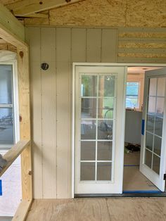 the inside of a house being remodeled with wood flooring and glass doors on both sides