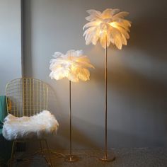 two lamps that are next to each other in a room with a chair and rug