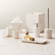 marble bathroom accessories including soap dispenser, toothbrush holder and soap dish