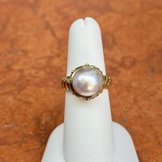 New, but old pieces, never worn, recently acquired from a premier jeweler located in Minneapolis, MN for many years- A rare opportunity! 14KT yellow gold genuine, bezel-set, Mabe pearl ring with Etruscan/ filigree design. Size 6.25 Sizable by us for a fee or your local jeweler Weight: 7.90 grams Band width: 4mm 11mm pearl Stamped 14k Mabe Pearl, Filigree Design, Pearl Ring, Bezel Setting, Minneapolis, Yellow Gold, Size 6, Band, Ring