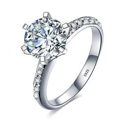 a white gold engagement ring with diamonds on the sides and a center stone in the middle