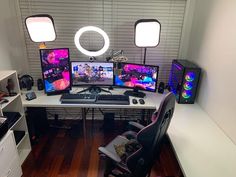 there are three computer screens on the desk