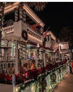 people are walking down the street decorated for christmas