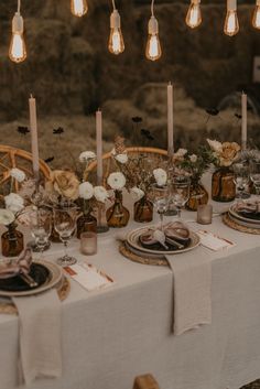 the table is set with candles, plates and napkins for an elegant wedding reception