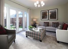 a living room filled with furniture and a large window