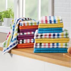 a stack of colorful towels sitting on top of a counter