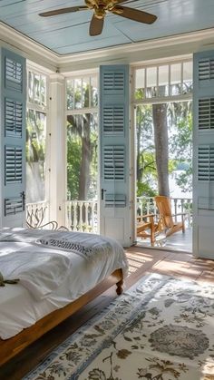 a bedroom with blue shutters and a bed