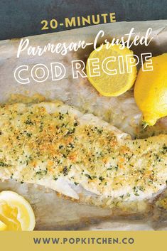 a close up of fish with lemons and parmesan crust