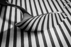 black and white striped fabric with a spoon on the table top in front of it