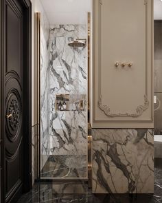 an elegant bathroom with marble walls and flooring, gold trimming on the doors