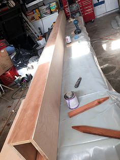 the inside of a garage with tools and supplies on the floor next to it,