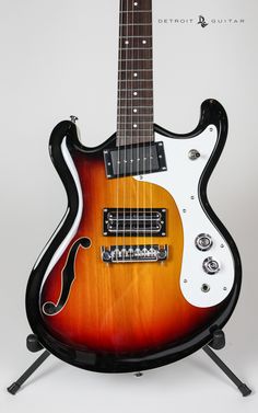 an electric guitar sitting on top of a stand