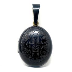 "Victorian 'Amity, Eternity, Infinity' Whitby Jet Mourning Black Memento Mori Locket Pendant. A very lovely and elegant black hand carved Whitby Jet with brass oval mourning locket. It has hand carved letters 'AEI', which stands for 'Amity, Eternity, Infinity'. It is in excellent condition with only surface scratches, but they aren't noticeable in person since the locket is black. The locket opens to reveal 2 original frame inserts and acetate covers to keep photos well protected. This is truly Formal Black Engraved Jewelry, Antique Black Engraved Jewelry, Ceremonial Black Engraved Jewelry, Black Oval Engraved Jewelry, Oval Black Engraved Jewelry, Antique Black Jewelry For Ceremonial Occasions, Antique Black Ceremonial Jewelry, Vintage Black Ceremonial Jewelry, Classic Black Medallion Jewelry