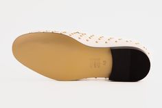 Materials Upper: LeatherLining: LeatherSole : Leather Step into refined elegance with our white leather shoes, a sophisticated addition to your footwear collection. The exterior showcases a sleek patent leather finish, while the interior and sole are meticulously crafted from premium leather, ensuring both style and comfort. The edges of the shoe are adorned with gold spikes, adding a touch of edgy sophistication to the design. At the top, a dazzling gold buckle takes center stage, creating a fo Cream Leather Sole Loafers For Business, Cream Loafers With Leather Sole For Business, Cream Leather Sole Loafers For Formal Occasions, Formal Cream Loafers With Leather Sole, Cream Formal Loafers With Leather Sole, Elegant White Loafers With Leather Lining, Luxury White Business Loafers, Luxury White Loafers With Brogue Detailing, Elegant Formal Leather Shoes With Studded Rubber Outsoles