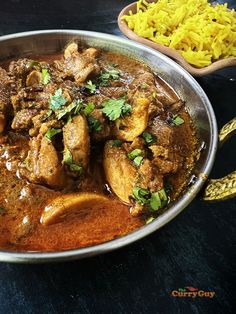 a large metal bowl filled with meat and rice