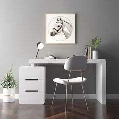 a white desk with a chair and potted plant on it in front of a gray wall