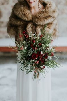 a woman wearing a fur stole holding a bouquet