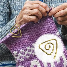 an older woman holding a knitted purse with the letter p on it, in front of her