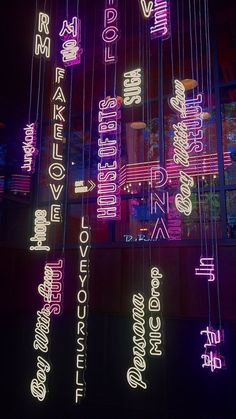 neon lights hanging from the ceiling in front of a building