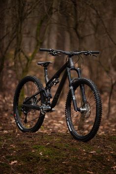 a mountain bike is parked in the woods