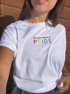 Say it loud and say it proud with this multicolour, embroidered, slogan tee! Each organic, unisex top is embroidered to order with the slogan "All You Need is PRIDE" in rainbow colours so that you can celebrate LGBTQ+ month all year round.  Approximate T shirt Chest Measurements:  XS - Chest 36-38", Length 27" S - Chest 38-40", Length 28" M - Chest 40-42", Length 29" L - Chest 43-45", Length 30" XL - Chest 46-48", Length 30" XXL - Chest 48-50", Length 30.5" 3XL - Chest 51-53", Length 31.5"  Pers Pride Parade Outfit, Pride Tees, Slogan Tshirt, Bright Rainbow, Rainbow Colours, Embroidered Tee, Slogan Tee, Pride Tshirts, Add Text