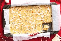 a loaf of bread sitting on top of a pan next to a red table cloth