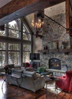 a living room filled with lots of furniture and a fire place in the middle of it