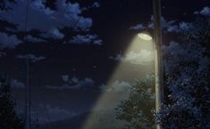 a street light in the middle of a night sky with clouds and stars above it