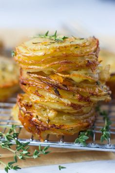 some food that is sitting on a metal rack and has herbs on top of it